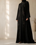 Black open-front abaya with floral embroidery worn over a matching inner layer