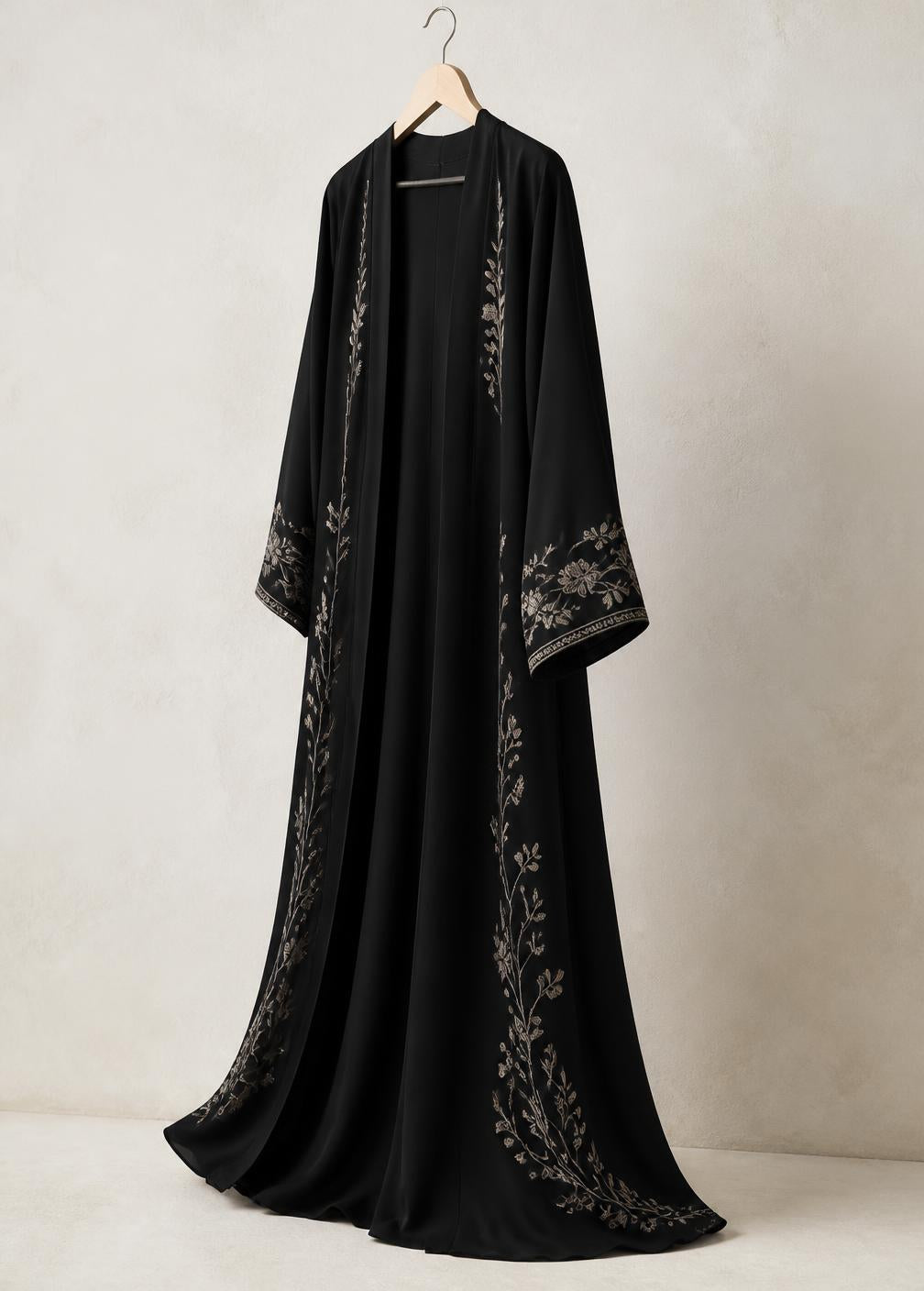 Black abaya with floral embroidery shown at a three-quarter angle